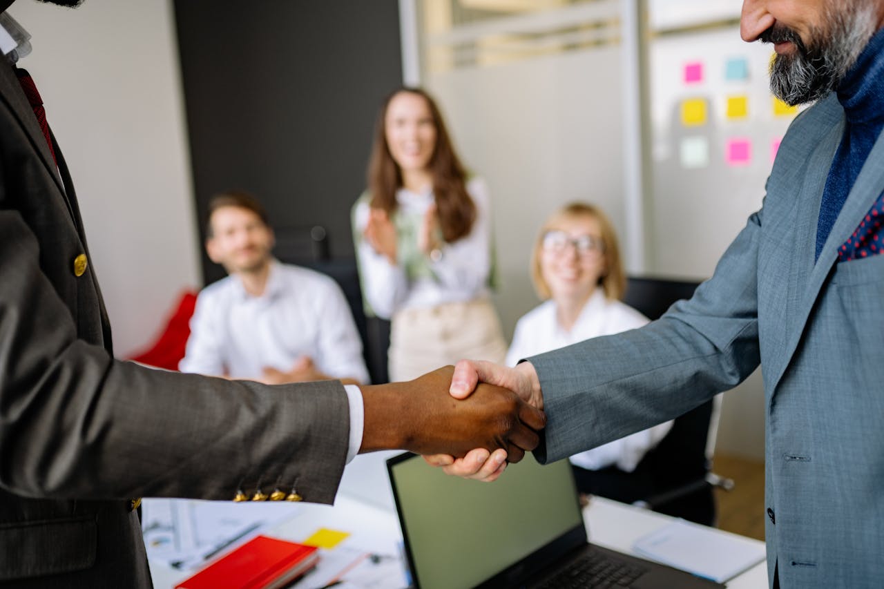 A diverse team shaking hands in a partnership meeting